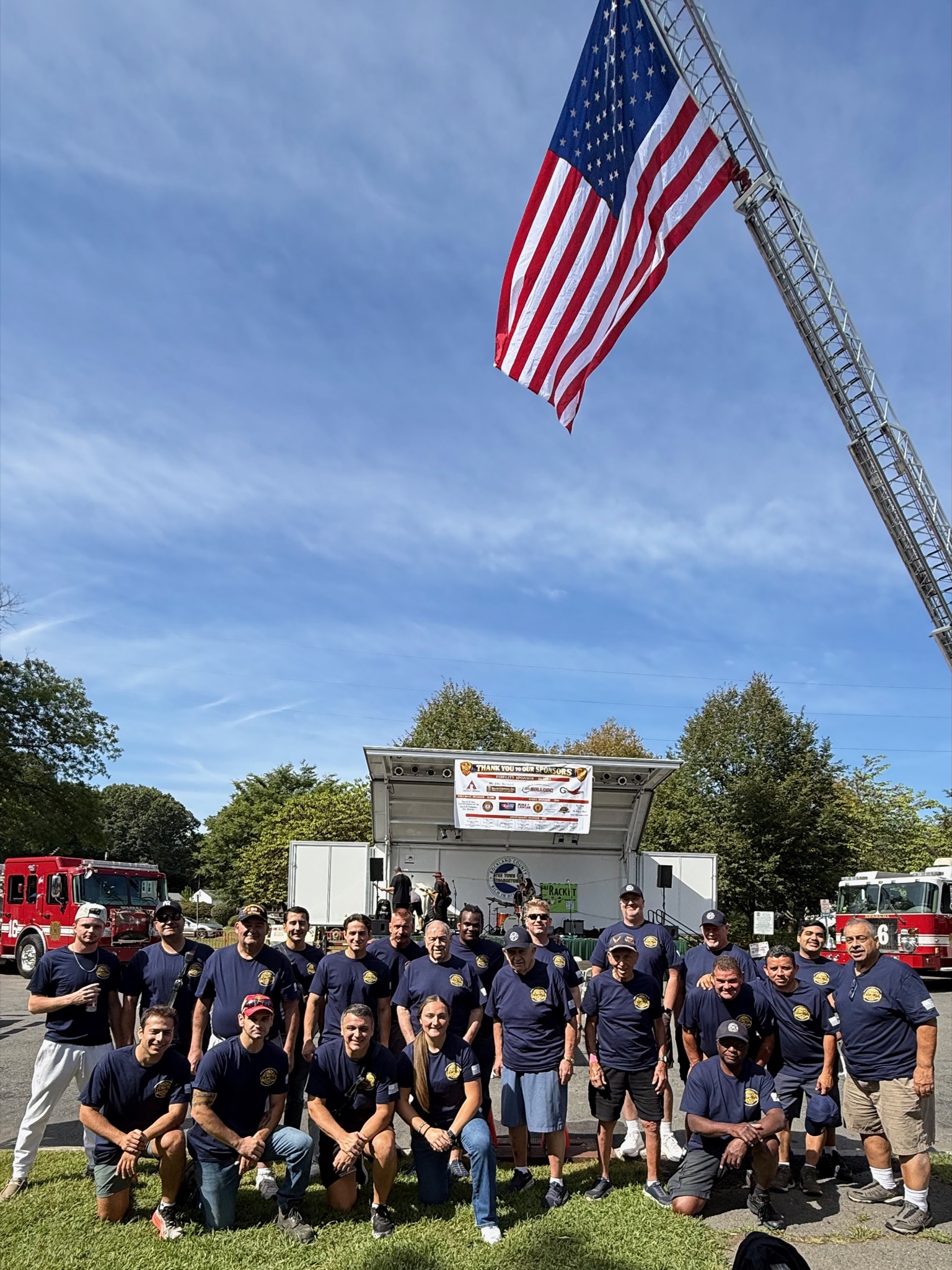 Department gathered under the giant American flag at Depot Square